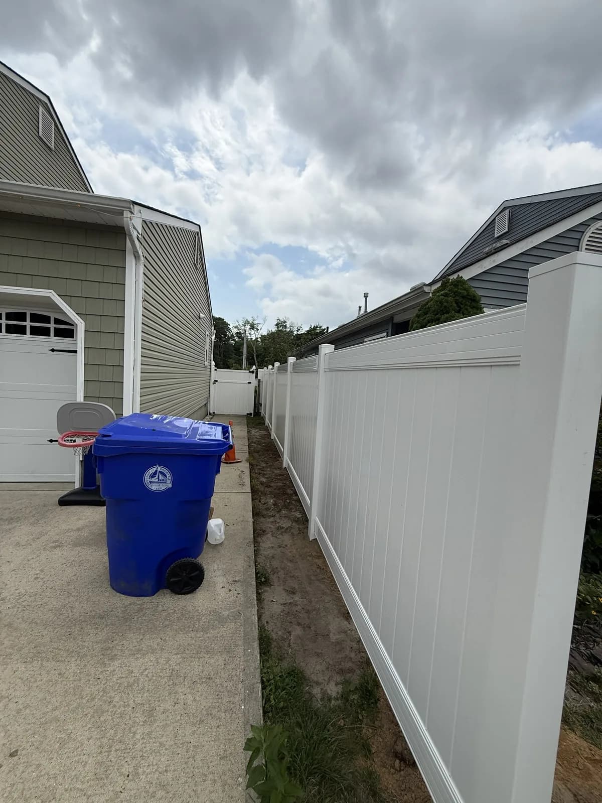 Side-Yard Privacy Run โ white vinyl privacy fence installed by Sandy Shores Fences in Brick, NJ